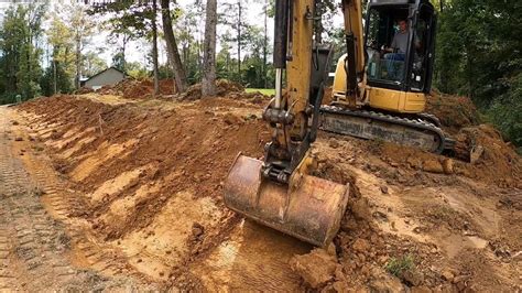 digging drainage ditch with mini excavator|digging a ditch with a mini.